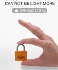 Hand holding a small orange lock showcasing Set Of Eight 30mm Aluminum Weatherproof Padlocks Keyed Alike With Vinyl Covered Bodies