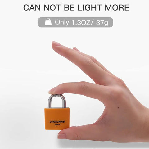 Hand holding a small orange lock showcasing Set Of Eight 30mm Aluminum Weatherproof Padlocks Keyed Alike With Vinyl Covered Bodies