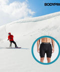 Snowboarder wears Gnarly Protective Padded Shorts with 3D hip, butt, and tailbone protection shown in detail.