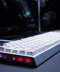 Rig Ready Aluminum Gaming Keyboard Featuring Smooth As Butter Mx2A Red Switches For Lightning Fast Response And Tight Control Paired With Vivid Rgb Lighting Sleek White Build And Reliable Wired Setup Control in low angle view