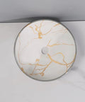 Round ceramic vessel sink with golden marble pattern, stylish bathroom wash basin, ideal for home and hotel use.