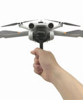 Grab And Go Handheld Drone Mount For DJI Mini 3 Pro, shown in user's hand, front view, takeoff and landing bracket attached.