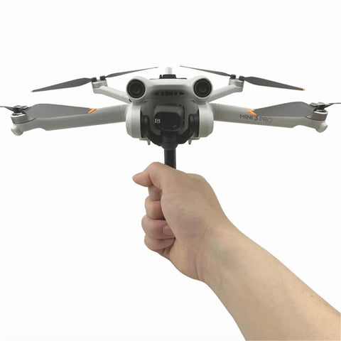 Grab And Go Handheld Drone Mount For DJI Mini 3 Pro, shown in user's hand, front view, takeoff and landing bracket attached.