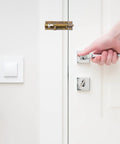 Heavy Duty Stainless Steel Rust Resistant Snap Lock For Door Gate Garage And Shed With Padlock Hole For Badass Barn Security Built Tough To Keep Your Spot Secure Zero Drama, installed on a white door.