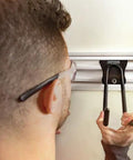 Person installing VersaTrack Garage Storage Rail With Twenty Piece Mounting Accessories For Drywall Studs And Masonry Pegboard Ready Patented Hooktite Latching on wall