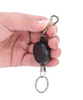 Hand holding an Extendable Keychain With Retractable Cord, 60cm Steel Wire Rope Key Reel, Heavy Duty Key Ring in ABS and Stainless Steel