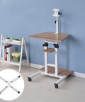 No Sweat Adjustable Standing Laptop Cart With Durable Wheels For Effortless Rolling Anywhere Ergonomic Sit Stand Computer Table For Chill Bedrooms Or Hustle Ready Home Offices Brown with wooden top and wheels.