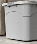 Heavy Duty Stackable Storage Totes With Secure Hinged Lids And Smooth Rolling Casters Plus Reinforced Side Handles For Clutter Free Closet Organization And Dorm Spaces, gray plastic tote on shelf.