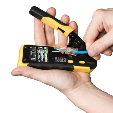 Hands using ratcheting modular data cable crimper wire stripper and cutter for RJ11 RJ12 RJ45 pass-thru connectors all in one tool