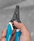 Hand holding Pro Grade Wire Stripper And Cutter For 8 To 18 AWG Solid And 10 To 20 AWG Stranded Wire With Six Precision Ground Stripping Holes Narrow Head For Tight Corners Made In USA Durable Hand Tool For DIY And Pros