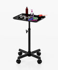 Adjustable Height Rolling Salon Cart With Tray On Durable Wheels For Tattoo Parlors Spas Dental Clinics And Hair Stylists Built From Corrosion Resistant Iron And Aluminum Anti Tip Design Lockable Casters Stable Mobile Workspace Black, shown with tools and supplies on tray.
