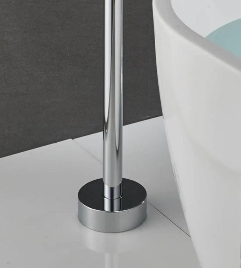 Close-up of floor-mounted chrome bath tub faucet base next to a clawfoot tub, part of free standing bathroom mixer tap setup.
