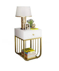 Sleek Metal Bedside Table With One Drawer Smooth Nightstand And Sofa Side Cabinet For Modern Bedroom featuring a gold frame and lamp.