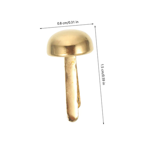 Close-up of a golden tack, 0.8 cm wide, 1.5 cm long, from 100 Piece Decorative Tacks And Miniature Nails For DIY Crafting Go To Fasteners Jewelry Box Projects Paper Clips For Photos Cards And More Durable Wear Resistant Brads For Scrapbooking And Home Decor.