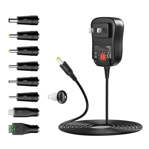 Universal 24W Multi Voltage AC DC Power Adapter with adjustable 3V-12V output, cable, and interchangeable tips for gadgets.