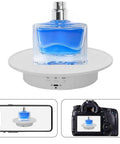 JAYEGT Motorized Rotating Display Stand, 7.87 Inch 360 Degree Electric Turntable showcasing a blue perfume bottle, compact design.
