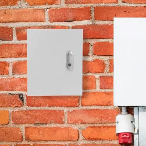 Metal Junction Box 250x300x140mm Rugged Wall Mounted Electrical Enclosure on red brick wall, with secure lock.