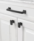 Close-up of a cabinet with an installed 5 inch matte black kitchen cabinet handle from the 10 pack collection, enhancing modern decor.