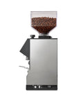 Silent conical burr grinder with coffee beans in clear hopper, part of Level Up Your Home Barista Setup With This Sleek Copper And Chrome Espresso Machine Paired With A Silent Conical Burr Grinder In A Complete Bundle Crafted For Smooth Extractions And Effortless Daily Coffee Vibes.