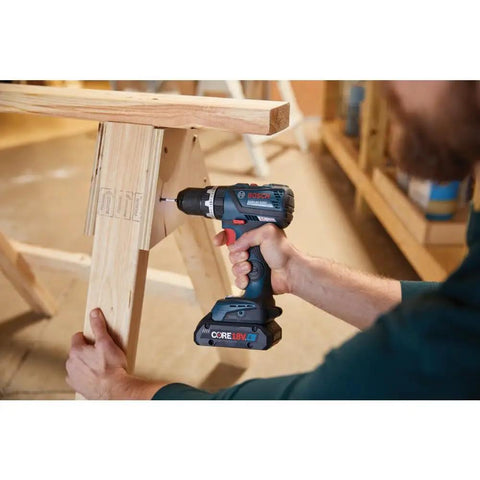 Person using 18V Brushless Hammer Drill Driver With Optional Bluetooth Connectivity Module Compact Half Inch Cordless Drill Kickback Control 20 Plus 1 Clutch EC Motor Bare Tool For Tough Jobs on wooden structure