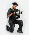 Filmmaker using Wearable Camera Stabilizer Harness That Turns Your Body Into A Moving Tripod For Heavy Rigs, including DSLR cameras.