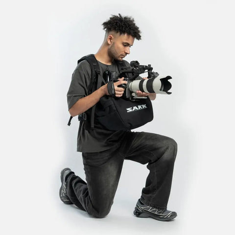Filmmaker using Wearable Camera Stabilizer Harness That Turns Your Body Into A Moving Tripod For Heavy Rigs, including DSLR cameras.
