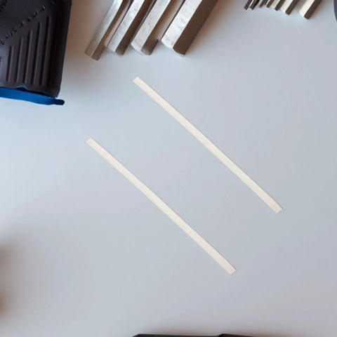 Grab This 40-Pack of White Pp Plastic Welding Rods For Car Bumper Repair! Two white PP plastic rods on a work surface.