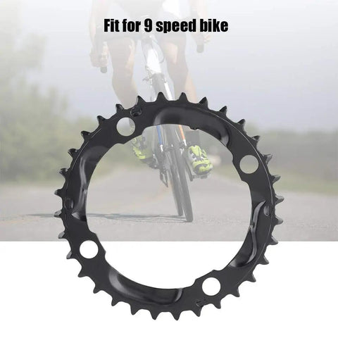 32T 104mm BCD Steel Round Chainring For 9 Speed Mountain Bikes Beefy Steel Build With Quiet Ride And Top Notch Chain Retention Durable MTB Replacement Part on a blurred bike ride background