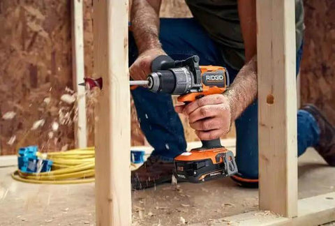 Pro Grade Brushless 18 Volt Cordless Drill Driver Kit With Compact Battery And Quick Charger being used to drill into wood stud.