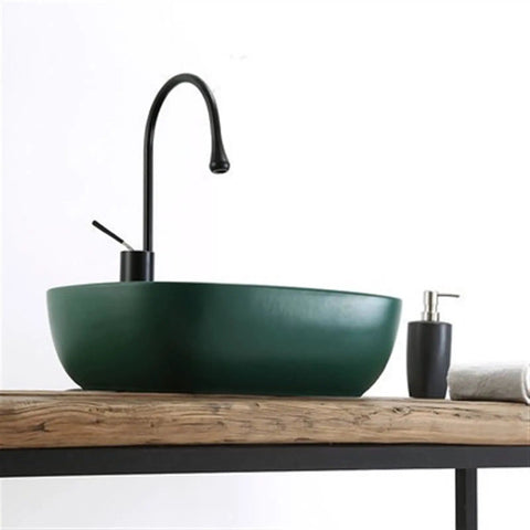 USZWBY Matte Green Rectangle Bathroom Vessel Sink - Ceramic Art Basin with Drainer Stylish Countertop Sink for Modern Bathrooms on wooden countertop.