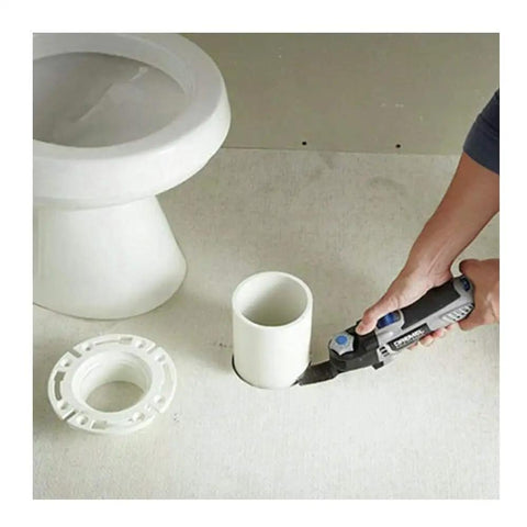 Person using 5 Amp Tool-Less Oscillating Tool Kit With Accessory Set For Cutting Sanding Grinding And Scraping on PVC pipe near toilet