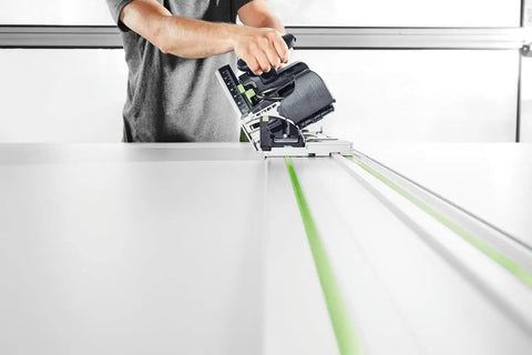 Person using Plunge Cut Saw With Scoring Function TSV 60 KEB F Plus Diamond Scoring Blade for precise wood panel cutting.