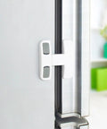 Kidproof Fridge Lock For Cabinets And Drawers Anti Pinch Plastic Strap Latch installed on grey fridge door