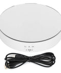 This Awesome Electric Rotating Turntable Display Stand Boasts Heavy Duty 10KG Load Bearing Power For Glittering Jewelry Watches And Digital Gadgets With Smooth Two Way Spin Action And Sleek Mirror Finish Built Tough! top view showing USB power cord and controls.