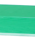 Green rectangular solid, unidentified item with small circular opening on one side.