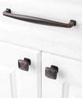 Ten Pack Oil Rubbed Bronze Cabinet Knobs Set For Cabinets And Drawers Square Single Hole Pulls For Dresser Cupboard Bedroom Closet And Bathroom Vanity Made From Solid Metal For Durable Easy Install Hardware The Best Bang For Your Buck shown on white cabinet doors.