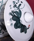 Lid of retro ceramic rice dispenser featuring floral design and smooth finish, enhancing kitchen decor. Makes Your Kitchen Vibe Level Up With This Retro Ceramic Rice Dispenser That Traps Freshness For Flour Sugar And Coffee Beans Using A Dead On Airtight Seal And Trendy Tassel Handle Massive 25kg Canister.