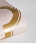 Close-up of metallic gold pattern on pink background from Pink And Metallic Gold Marrakesh Peel And Stick Wallpaper Removable.