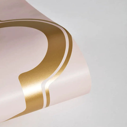 Close-up of metallic gold pattern on pink background from Pink And Metallic Gold Marrakesh Peel And Stick Wallpaper Removable.