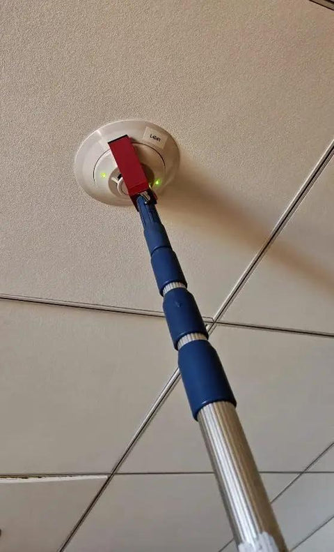 Rock Solid Dual Magnet Smoke Detector Test Tool For Fire Safety Systems With Quick Pole Thread Adapter in use testing a smoke detector.