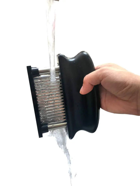 Meat Tenderizer With 48 Stainless Steel Needle Blades Heavy Duty Pro Grade Kitchen Tool being washed under running water
