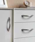 Brushed Nickel Cabinet Pulls 3 Inch Arch Twisted Silver Handles on white drawers and cabinets in kitchen