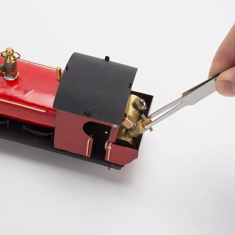Detail of 1/50 HO Live Steam Locomotive Model With Oscillating Steam Engine Kit for adults being assembled with tweezers.