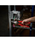 Person using 9 Inch Leverage Lineman Pliers With Crimper And Pipe Reaming Head to cut wires from electrical box installation.