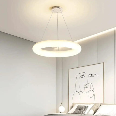 White Ring Acrylic LED Pendant Light for Bedroom, Modern Hanging Lamp, illuminating a contemporary neutral-toned bedroom