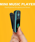 Hand holding 32GB Clip On MP3 Player With Bluetooth 5.3 For Sports, A65 Pedometer Music Player showing side view