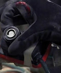 Gloved hand adjusting XtremeFLEX Mid-Temperature Silicone Heating Tape With Adjustable Thermostat Control around a pipe