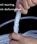 Clear silicone tubing, 1/4 inch ID, twisted by hands in close-up; flexible, food-grade hose