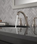 Woodhurst Brushed Nickel 8 Inch Widespread Bathroom Sink Faucet With 3 Hole Mount Stainless Finish in a modern vanity setting.
