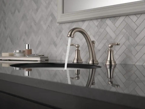 Woodhurst Brushed Nickel 8 Inch Widespread Bathroom Sink Faucet With 3 Hole Mount Stainless Finish in a modern vanity setting.